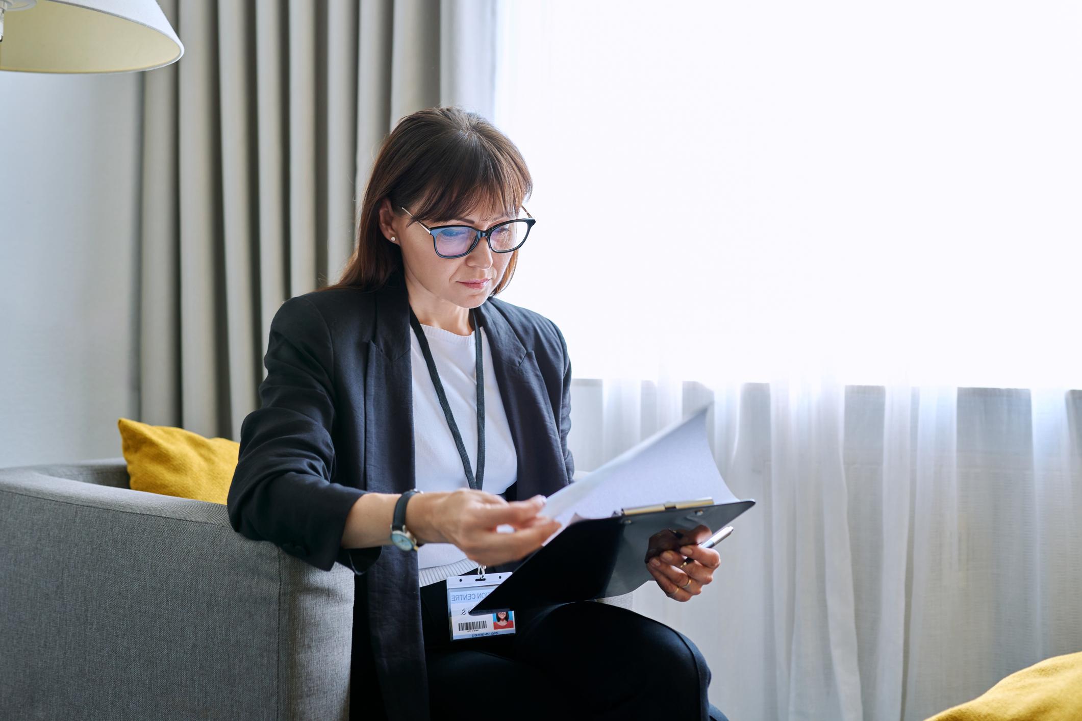 woman looking at a clipboard